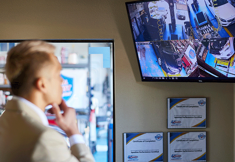 Man looking at four monitors showing what's happening in all the SpeeDee bays